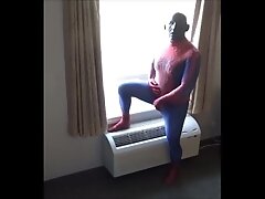 spiderman in black silicone mask jerking off at hotel window
