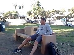 Risky public jerking completely naked on a park bench with traffic in the background