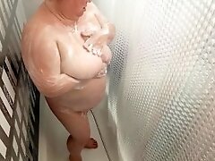 Mother-in-law takes a shower and washes her big tits
