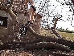 Tarzan Milf naked climbing tree in fields near hometown