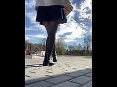 Hot MILF in stockings shines pussy in a public place